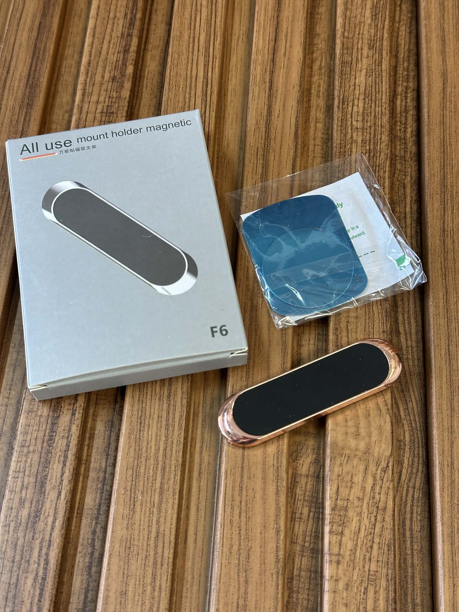 All use mount holder magnetic F6 packaging on a wooden surface with a black and rose gold mount.