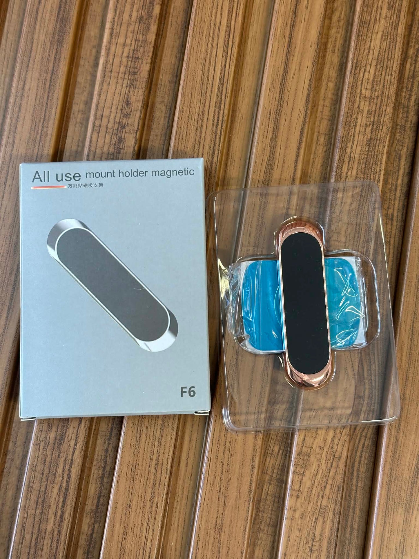 Magnetic mount holder with packaging on a wooden surface