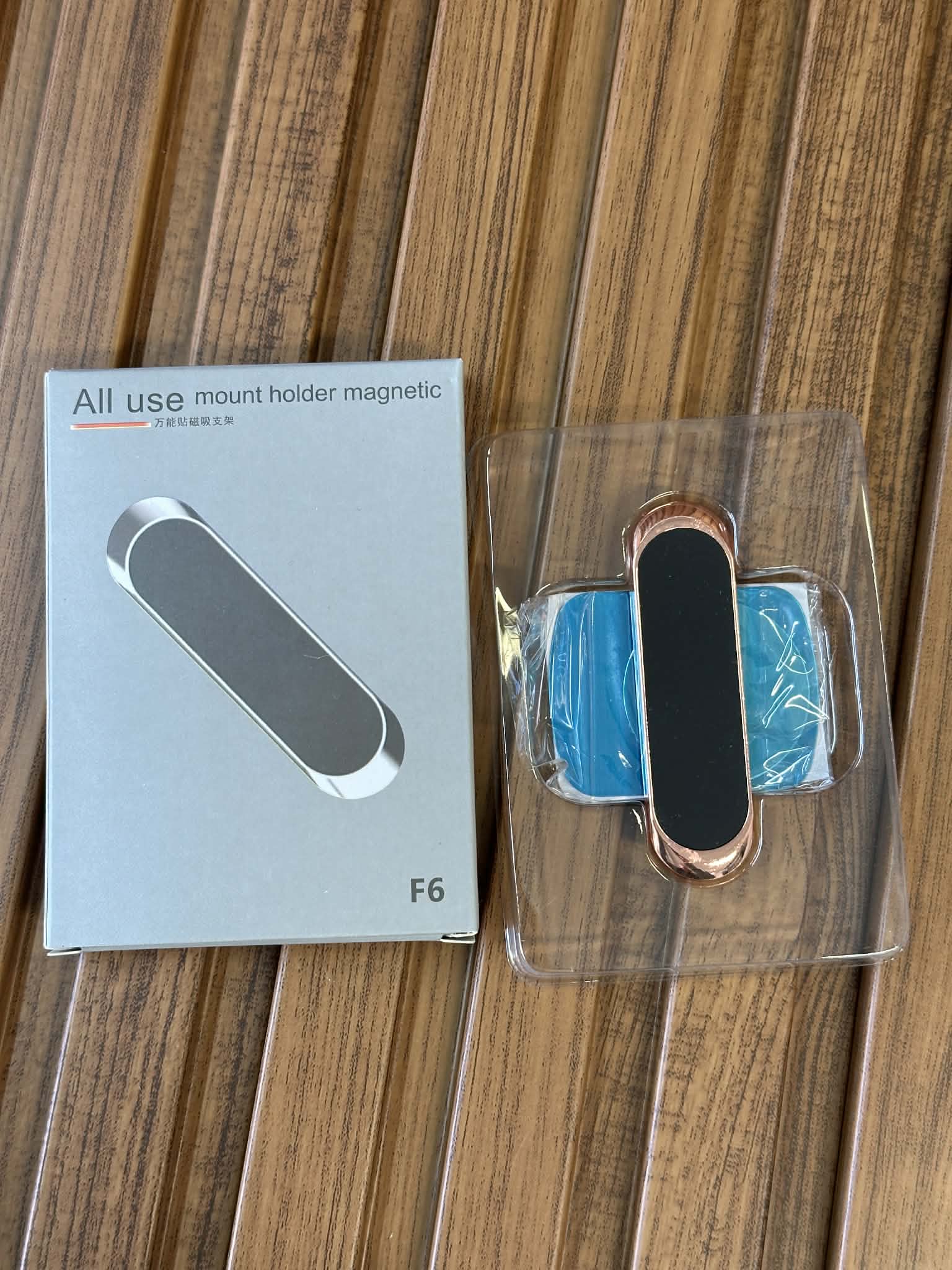 Magnetic mount holder with packaging on a wooden surface
