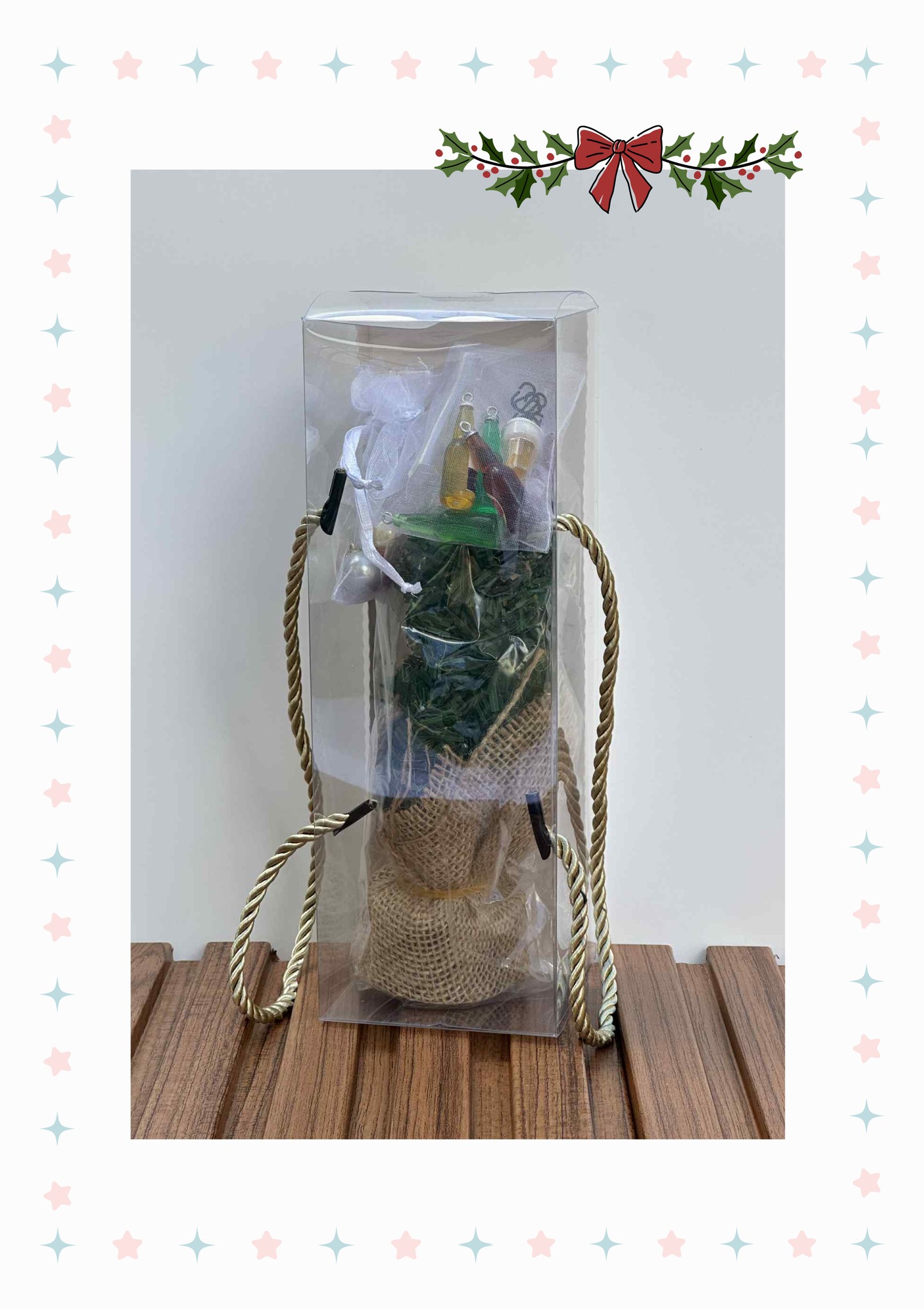 Gift bag with plants and decorative items on a wooden surface